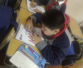 Shanghai exchange child using a protractor